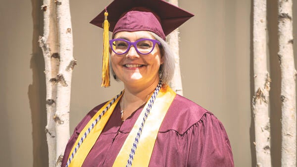 Kristine Anderson pictured wearing her ASU graduation gown and stole.