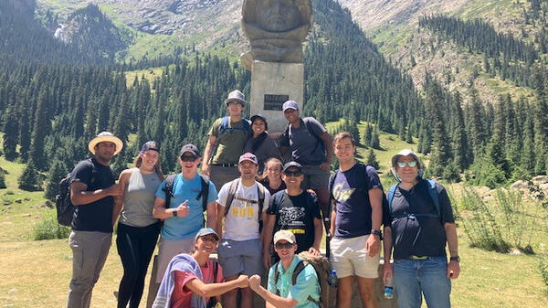 Group of students in front of statue of Soviet cosmonaut Yuri Gagarin.