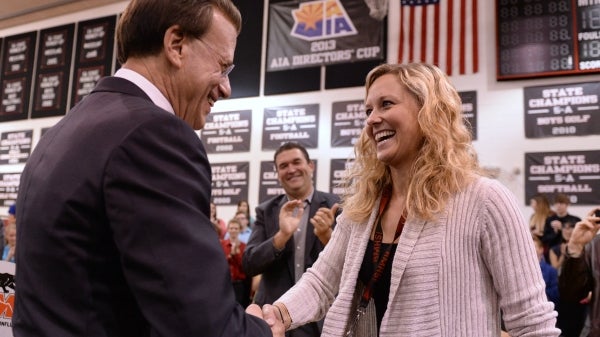 man shaking woman's hand