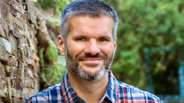 Portrait of ASU Associate Professor Matt Bell smiling for the camera in an outdoor setting.