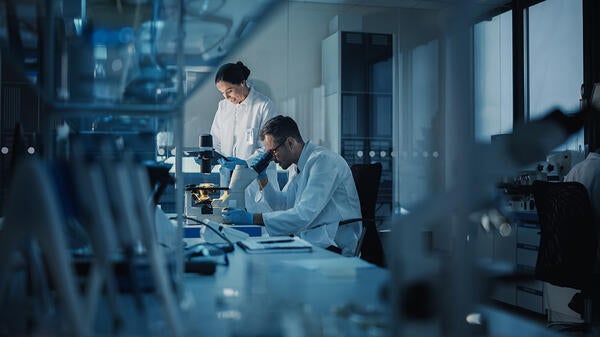 A man and a woman work in a medical research lab