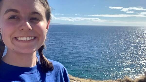 Smiling girl with ocean in background