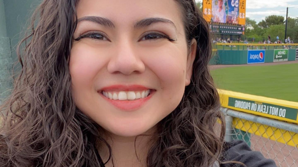 Photo of Mia at baseball field. 