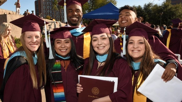 Master's degree graduates in caps and gowns