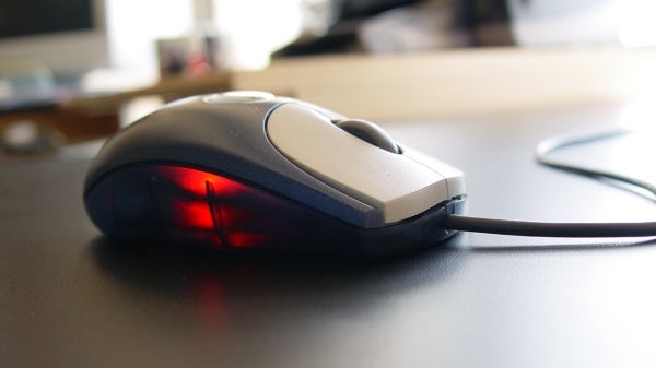 Computer mouse sits on a desk.