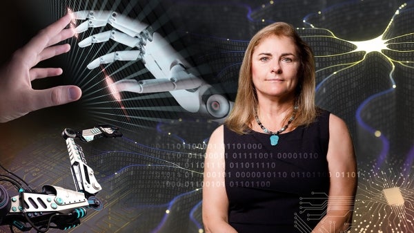 Portrait of woman in front of screen depicting robotics