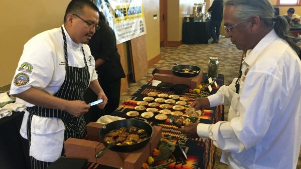 Chef Nephi Craig chats with attendee at RED INK Sustainability Dinner, April 22, 2017. / Photo by Henry Quintero