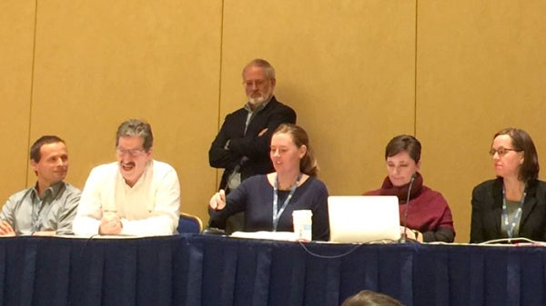 A group of people sit on stage for a medicine panel.