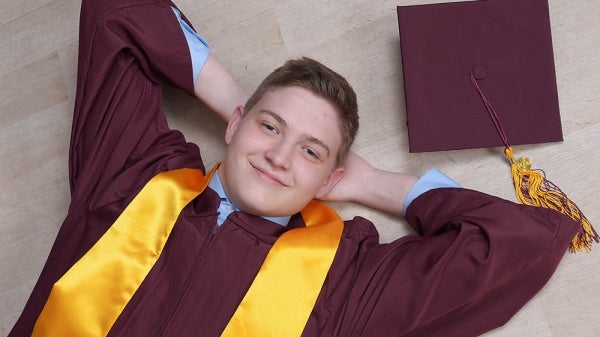 ASU graduate Nathan Reed with academic regalia