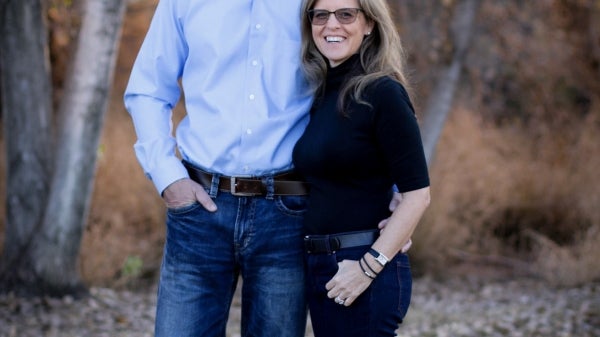 man and woman posing and smiling