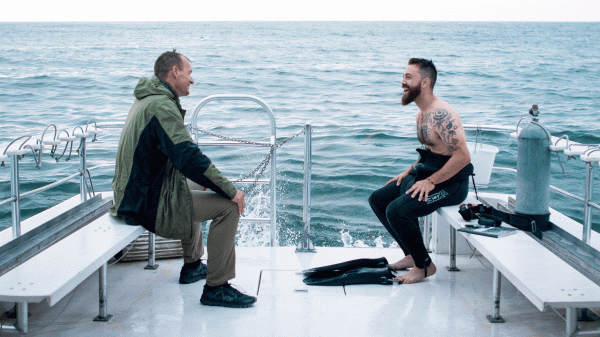 Two men on a boat in the ocean