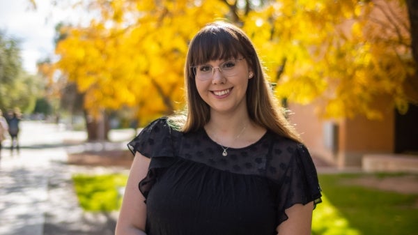 Kiana Guarino, a senior undergraduate psychology major at ASU, is pictured from midsection up smiling in an outdoor setting.