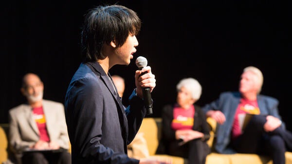 student speaking in microphone