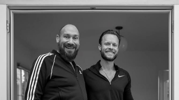 Black-and-white photo of Toby Prosky and Duncan Blount, creators of the Prosky Blount Scholarship for Interplanetary Prosperity, smiling at the camera.