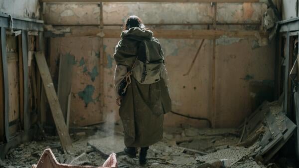 lone woman in ruined building