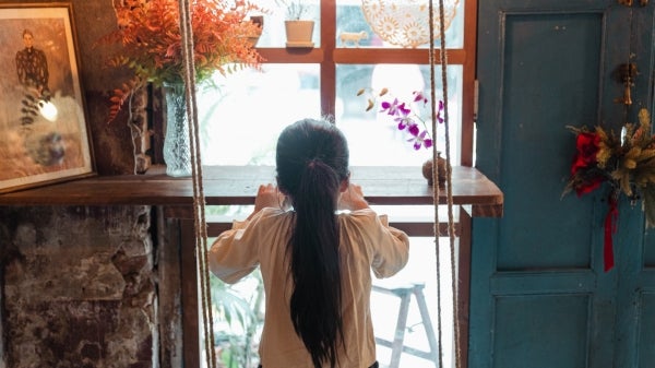 A child stares out a window.