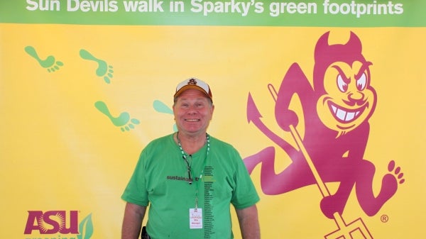 Rich Lemon poses for a photo with Sparky at Homecoming.