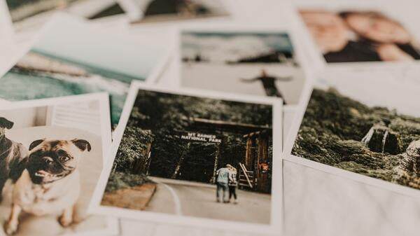 Polaroid snapshots scattered on a table.