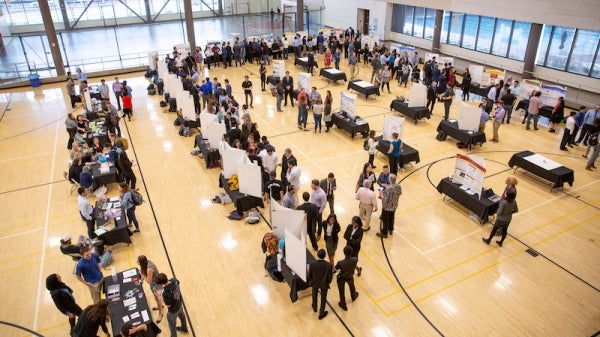 Engineering students and faculty gather for a capstone projects showcase event