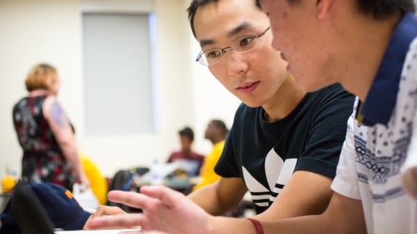 two students working together in class