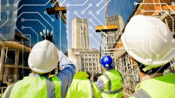 construction workers overlooking a city street