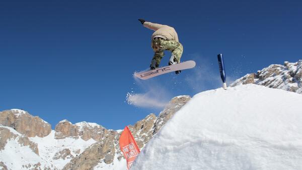 Snowboarder mid-jump.