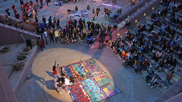 Hip-hop dancers perform and compete outside the ASU Art Museum while observers cheer them on.