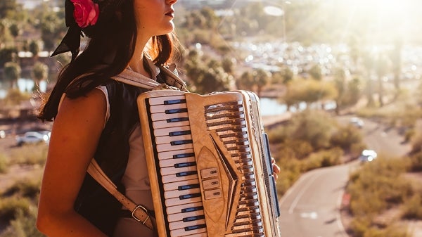 Tatiana Crespo poses outdoors in Phoenix with her accordion