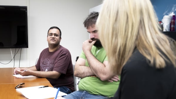 Zain Bukhari, a doctoral student at The College's School of Life Sciences, speaks to Linda Raish during a meeting for The College Ambassadors this summer.