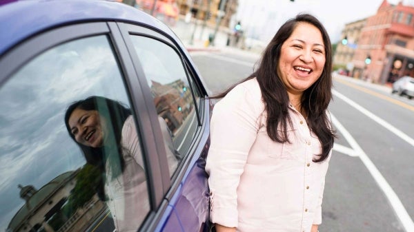 woman standing next to car