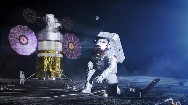 Astronauts in spacesuits near a landing craft on the moon