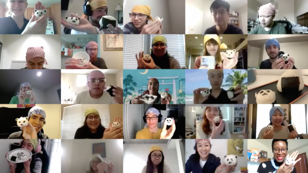 A screenshot shows 25 small images of workshop participants, taken over Zoom. Each person is holding up onigiri, a Japanese rice ball, that has been shaped to look like a panda.