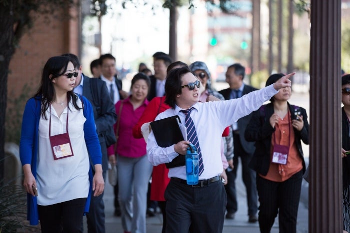 An ASU guide walking faculty from 10 Chinese universities through the ASU Tempe campus