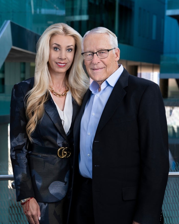 Rob and Melani Walton pose for a headshot outside ISTB7