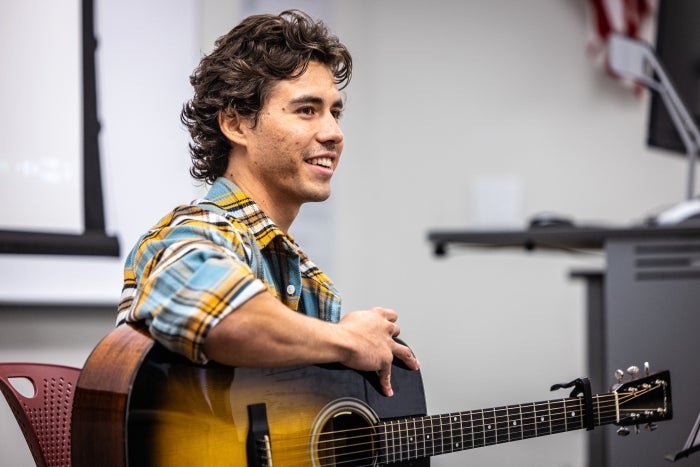 Man holding acoustic guitar