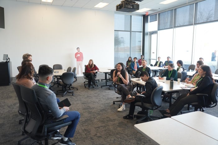 People seated in a conference room having a discussion.