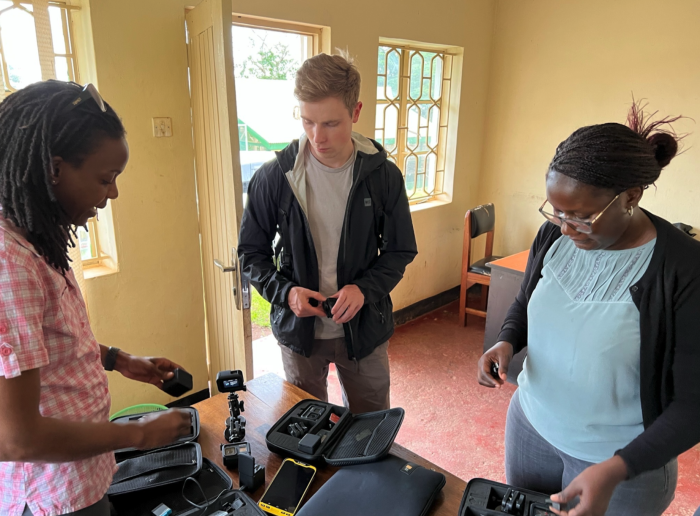 Three people prepping GoPro cameras