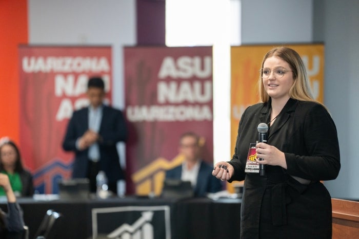 Woman speaking into a microphone.