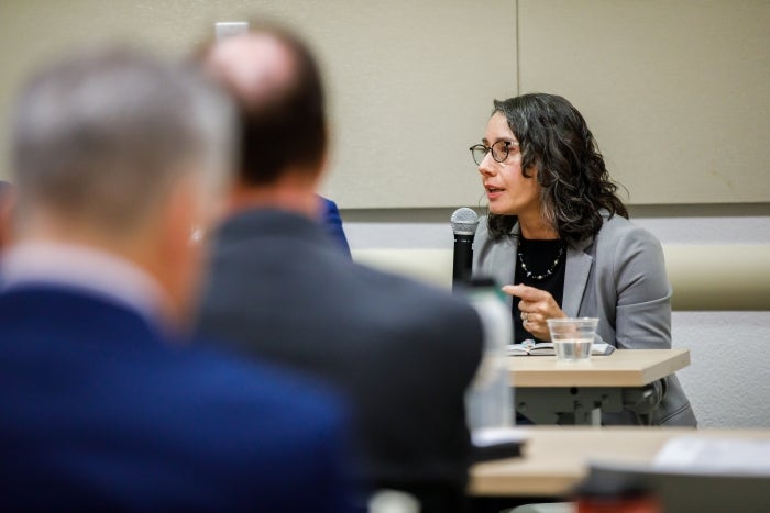 Woman on panel speaks during event