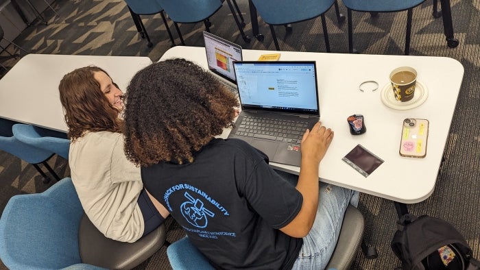 Students working on their laptops during the SpaceHACK event