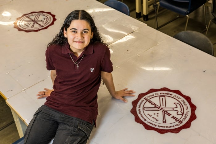 Young woman sitting on the floor smiling