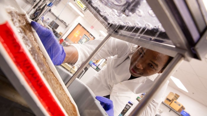 ASU student Henry Nakaana works in a lab for his FURI research project.