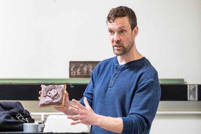 Man holding sculpture