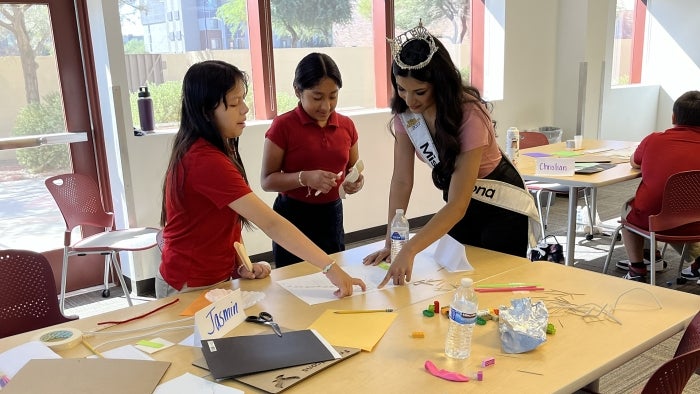 Tiffany Ticlo helps students with an art project.