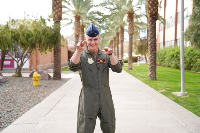 Anthony Jakubczyk holds two "forks up" on Palm Walk.