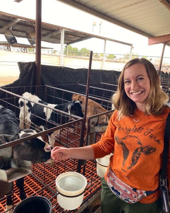 Elizabeth Reilly in a dairy farm, visiting Kerr Family Farms during their cohort's Arizona farm tour immersion.  