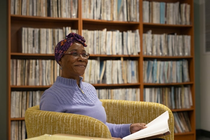 ASU student Shirley A. Mitchell-Valrie smiles off-camera sitting in front of a bookshelf