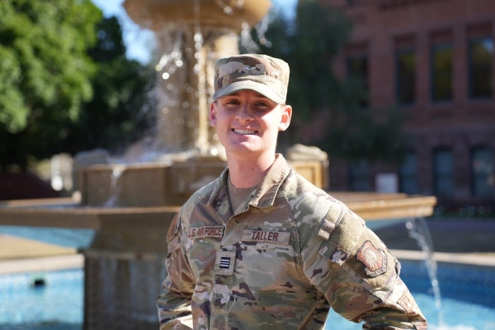 Andrew Taller stands in front of the fountain in front of Old Main.