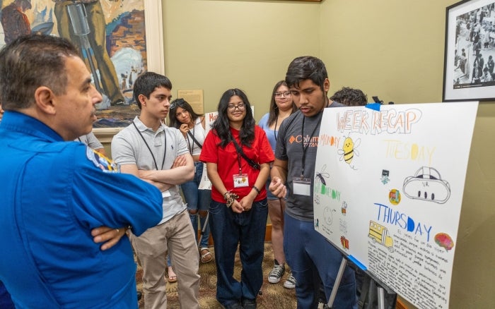 Students presenting a research poster.