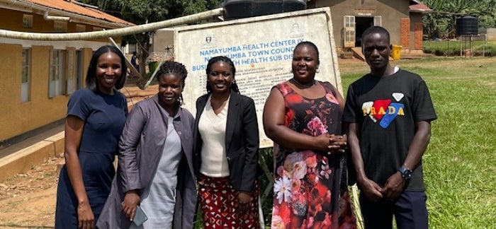 Counselors stand in front of an intervention center in Uganda